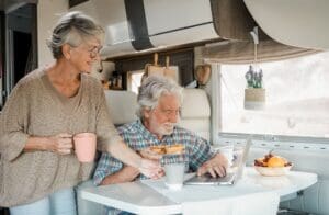 What to ask when shopping for an RV(/what-to-ask-when-shopping-for-an-rv/) – Elderly couple in travel vacation inside a camper 2023 11 27 05 00 04 utc